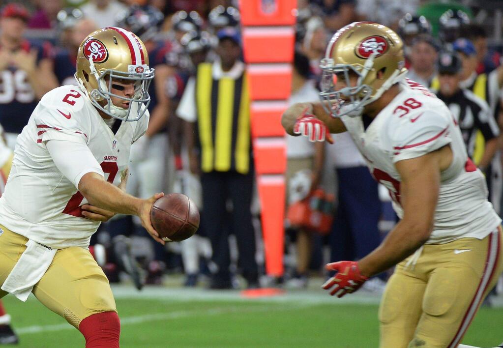 Jarryd Hayne gets his hands in place to take a handoff from Blaine Gabbert in the 49ers' exhibition opener at Houston. (George Bridges / Associated Press)