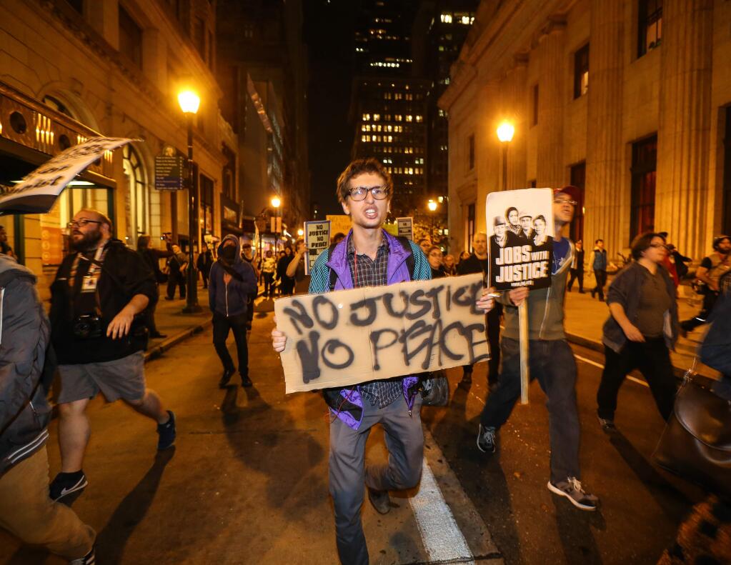 Marching on Chestnut street after the Ferguson verdict, in Philadelphia, Monday, Nov. 24, 2014. (AP Photo / The Philadelphia Daily News, Steven M. Falk )
