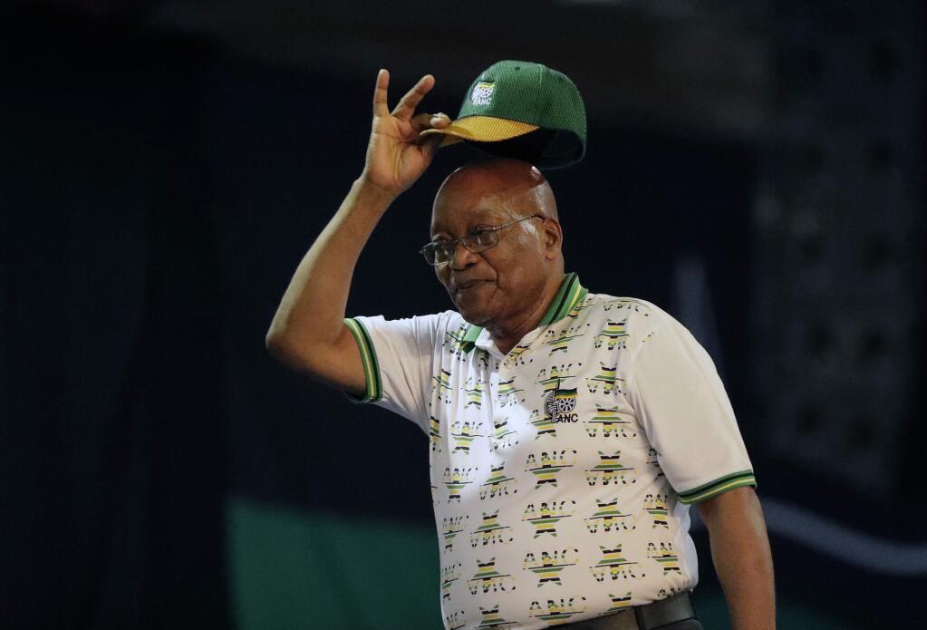 Outgoing ANC president and South African President Jacob Zuma, raises his cap after it was announced that Cyril Ramaphosa had won the vote at the ANC's elective conference in Johannesburg, Monday Dec. 18, 2017. Outgoing Zuma's second and final term as party leader has ended after a scandal-ridden tenure that has seen a plummet in the popularity of Nelson Mandela's liberation movement. (AP Photo/Themba Hadebe)