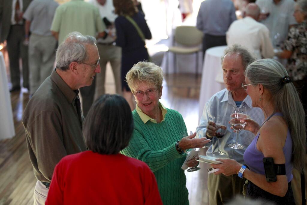 Gail Unzelman, center, talks with her husband, Ron, (from left) Callie Konno, Jim McCormick and Paula Freund during the Sonoma County Wine Library 25th Anniversary Gala at the DeTurk Round Barn in Santa Rosa on Sunday, Aug. 10, 2014. (BETH SCHLANKER / The Press Democrat)