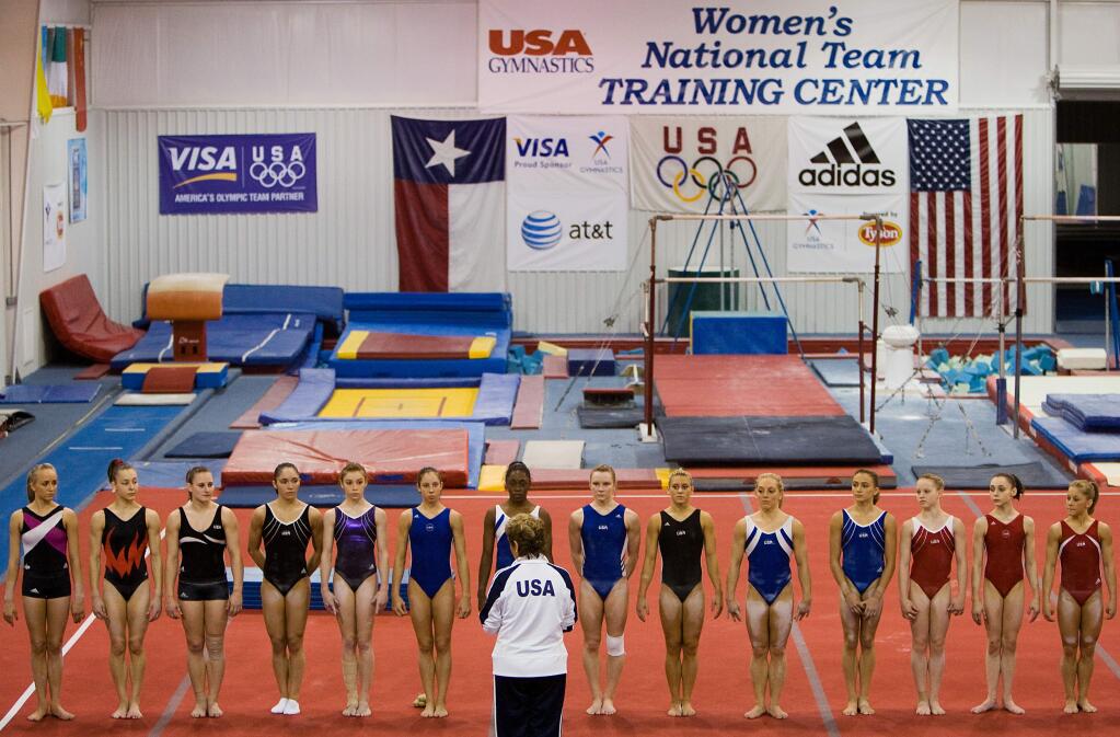 FILE - In this May 2008 file photo, gymnasts including Nastia Liukin, far left, and Shawn Johnson, far right, line up for Martha Karolyi during USA Gymnastics National Team training at the Karolyi Ranch, in Huntsville, Texas. Former USA Gymnastics women's national team coordinator Martha Karolyi and her husband Bela tell NBC they were unaware of the abusive behavior by a former national team doctor now serving decades in prison. Martha Karolyi led the national team for 15 years before retiring after the 2016 Rio Olympics. She tells Savannah Guthrie in 'no way' did she suspect Larry Nassar was sexually abusing athletes.(Smiley N. Pool/Houston Chronicle via AP, File)