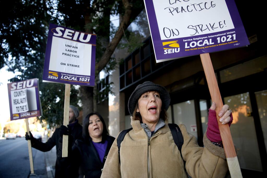 Kelly Brockway strikes with members of Service Employees Union Local 1021 in Santa Rosa, on Tuesday, Nov. 17, 2015. (BETH SCHLANKER/ PD)
