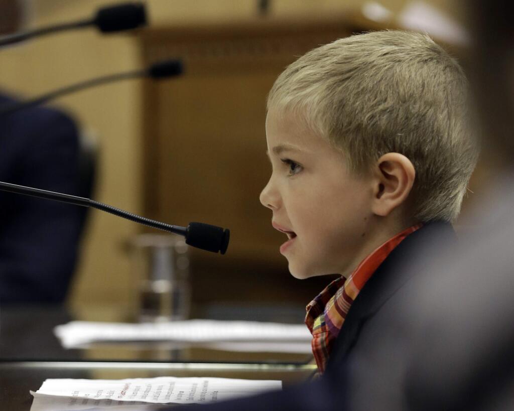 Rhett Krawitt, 6, who could not be vaccinated while he was being treated for leukemia, speaks to lawmakers about approval of a measure requiring California schoolchildren to be vaccinated during a hearing of the Senate Education Committee, Wednesday, April 15, 2015, in Sacramento, Calif. The bill authors, Sen. Richard Pan, D-Sacramento, and Sen. Ben Allen, D-Santa Monica, agreed to postpone a vote until next week after lawmakers expressed concerns. (AP Photo/Rich Pedroncelli)