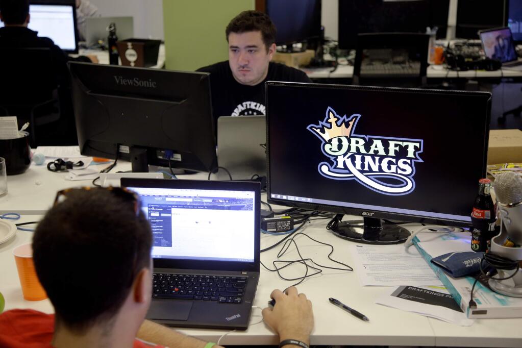 Len Don Diego, the marketing manager for content at DraftKings works at his station at the company's offices in Boston. (STEPHAN SAVOIA / Associated Press)
