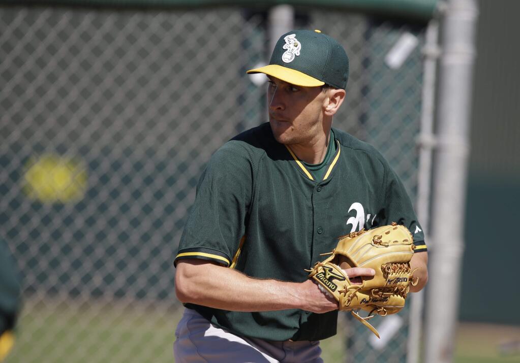 This Feb. 25, 2015, file photo shows the Oakland Athletics' Pat Venditte in action during spring training in Mesa, Ariz. (AP Photo/Darron Cummings, File)