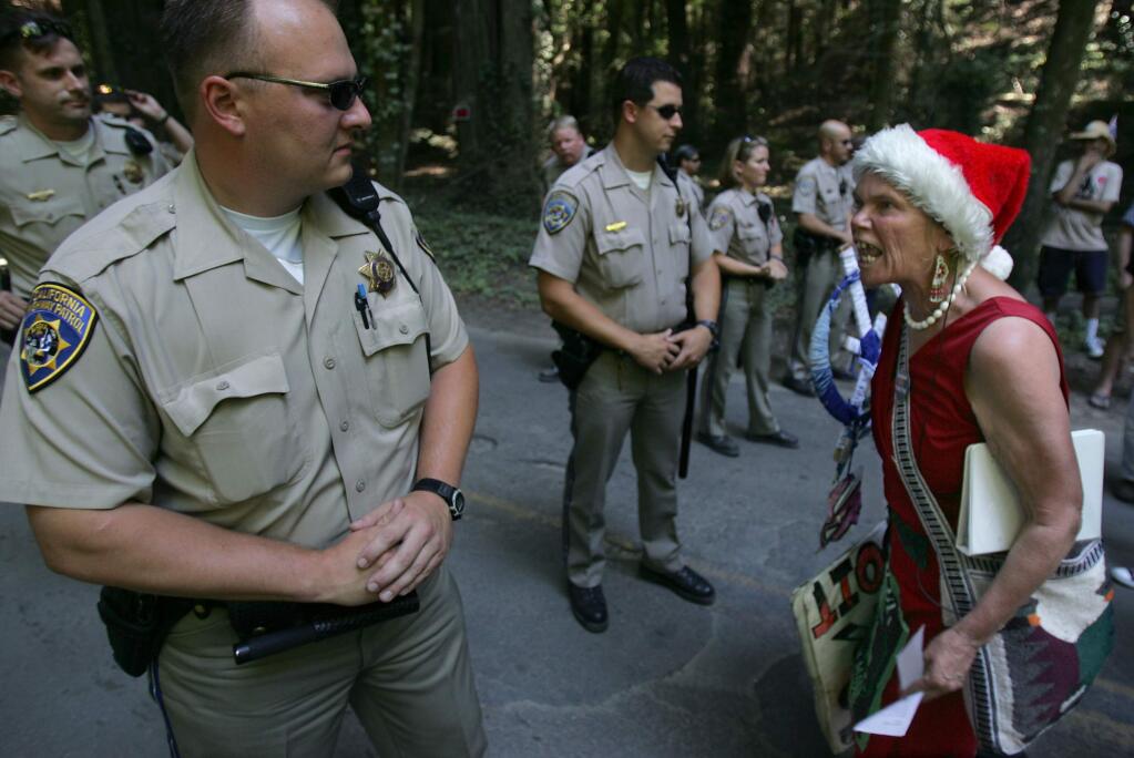 A protester who declined to give her name shouts out her feelings about the Bohemian Grove guests in Monte Rio in 2006. (KENT PORTER/ PD FILE)