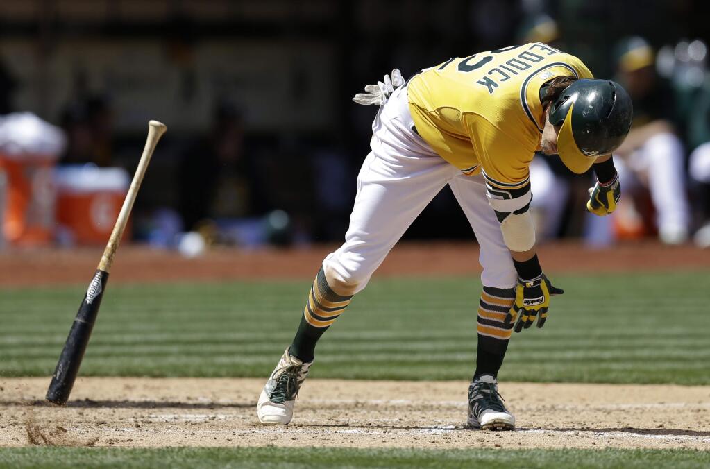 Oakland Athletics' Josh Reddick throws his bat after hitting a fly-out in the fourth inning of a baseball game against the Houston Astros, Sunday, April 26, 2015, in Oakland, Calif. (AP Photo/Ben Margot)