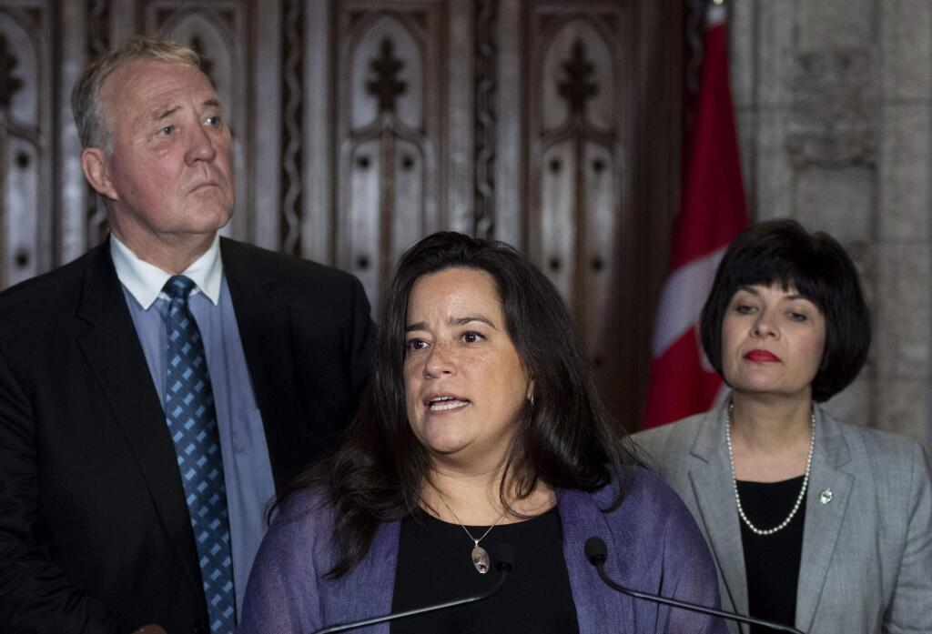 Minister of Justice and Attorney General of Canada Jody Wilson-Raybould speaks during a press conference as Minister of Health Ginette Petitpas Taylor, right, and Parliamentary Secretary to the Minister of Justice and Attorney General of Canada and to the Minister of Health Bill Blair, left, look on during a press conference on Bill C-45, the Cannabis Act, in the Foyer of the House of Commons on Parliament Hill in Ottawa, Ontario on Wednesday, June 20, 2018. The Canadian government said it will soon announce the date of when cannabis will become legal - but warns it will remain illegal until then. (Justin Tang/The Canadian Press via AP)
