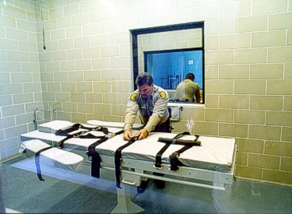 In this undated file photo provided by the Arizona Department of Corrections, an unidentified Arizona Corrections Officer adjusts the straps on the gurney used for lethal injections at the Arizona State Prison at Florence, Ariz. The prolonged execution this week of an Arizona death row inmate with a new, two-drug combination highlights the patchwork approach states have been forced to take with lethal injection drugs, with the types, combinations and dosages varying widely. (AP Photo/Arizona Department of Corrections)
