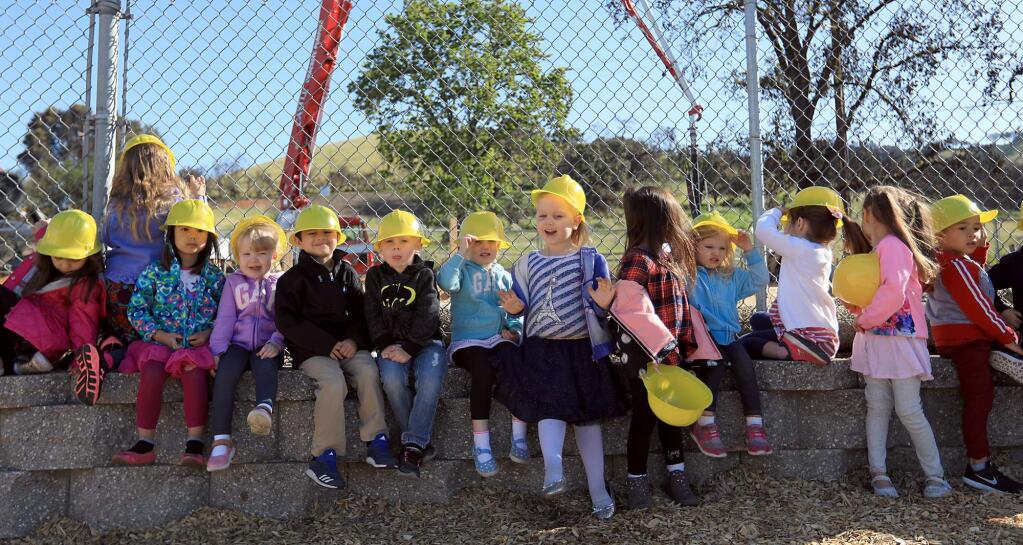 St. Rose Preschool students, Thursday, April 19, 2018 were on hand to watch construction crews pour the foundation of their new school, burned to the ground during the Tubbs fire last October. Students are using portables in the meantime. (Kent Porter / The Press Democrat) 2018