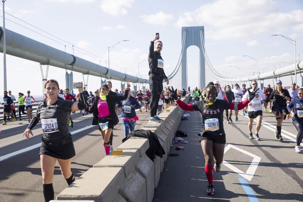 Runners make their way across the Verrazzano-Narrows Bridge during the start of the New York City Marathon, Sunday, Nov. 3, 2019, in New York. (AP Photo/Julius Motal)