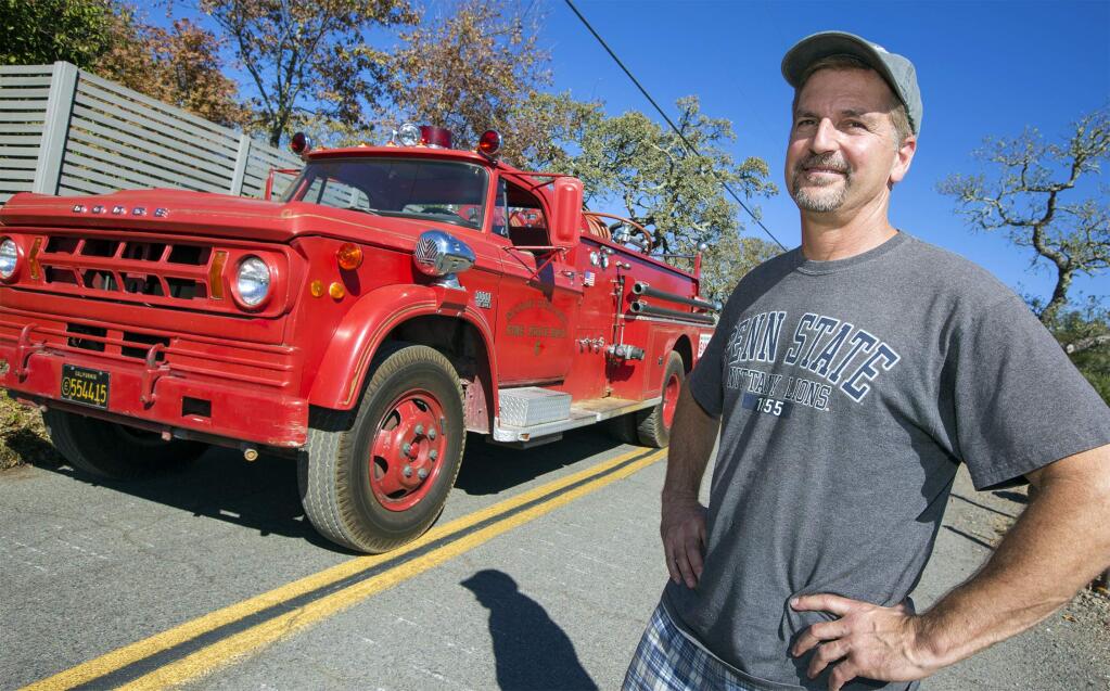 Tim Gray with his Mission Highlands fire truck. (Photo by Robbi Pengelly/Index-Tribune)