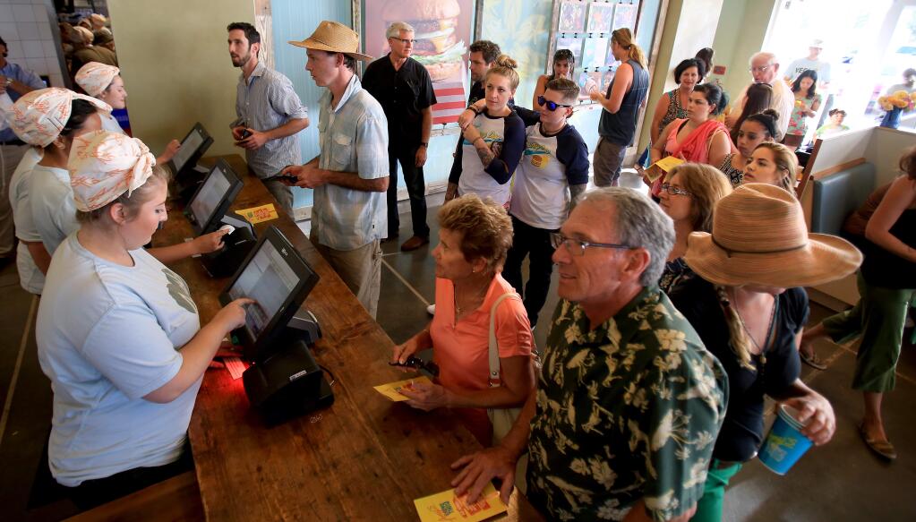 A line forms at Amy's Drive-Thru in Rohnert Park on the first day of business, Monday, July 20, 2015. (KENT PORTER/ PD)