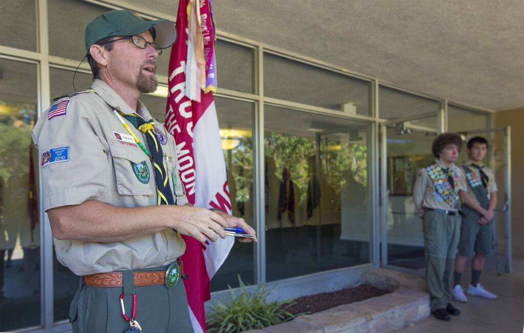Scoutmaster Bryan Aubin of Boy Scout Troop 222 calls onlookers to attention at the dedication ceremony for the flag repository.