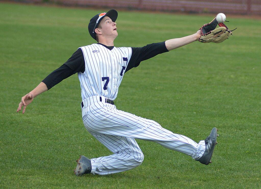SUMNER FOWLER/FOR THE ARGUS-COURIERPetaluma High School second basemaqn David Haulet makes a sliding catch in the Trojans' 6-5 win over San Lorenzo.