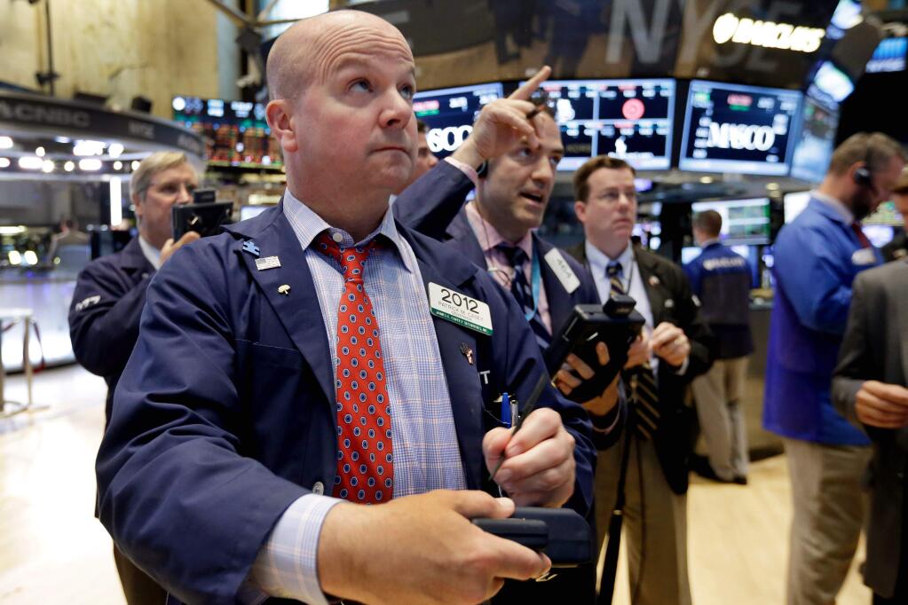 Specialist Patrick Casey, foreground left, works on the floor of the New York Stock Exchange, Tuesday, June 30, 2015. U.S. stocks gained on Tuesday afternoon, rebounding from big losses a day earlier, as investors followed the latest negotiations between the Greek government and its creditors. (AP Photo/Richard Drew)
