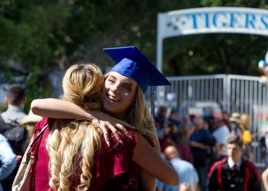 Graduate, Shawn Weichel, 18, right, hugs a friend before festivities at the class of 2018 commencement ceremony for Analy High School in Sebastopol, on Thursday, May 31, 2018. (Photo by Darryl Bush / For The Press Democrat)