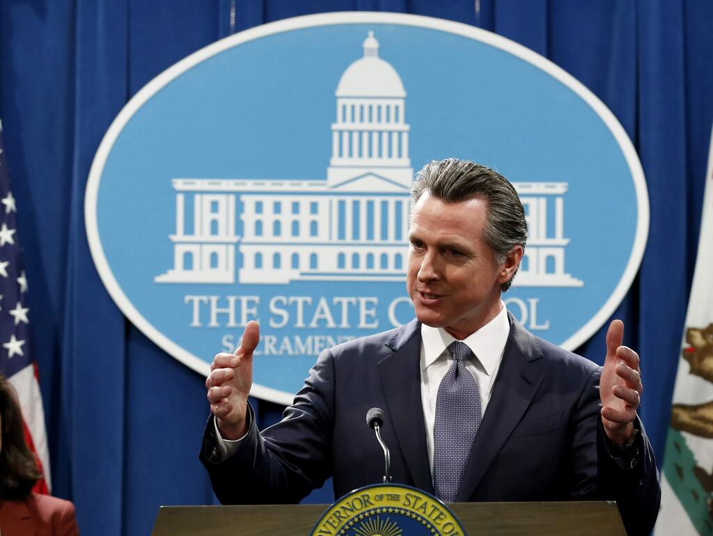 FILE - In this March 12, 2020, file photo, California Gov. Gavin Newsom speaks to reporters about his executive order advising that non-essential gatherings of more than 250 people should be canceled until at least the end of March, during a news conference in Sacramento, Calif. Newsom has approved 45 of California's 58 counties to reopen some businesses since May 8 when he loosened his original mid-March stay-at-home order. Los Angeles County, where more than 2,400 have died, is moving more cautiously, on Friday, May 22, 2020, allowing curbside pickup to resume at indoor malls. Rural Modoc County, where no cases have been reported, reopened businesses the first week of May. (AP Photo/Rich Pedroncelli, File)