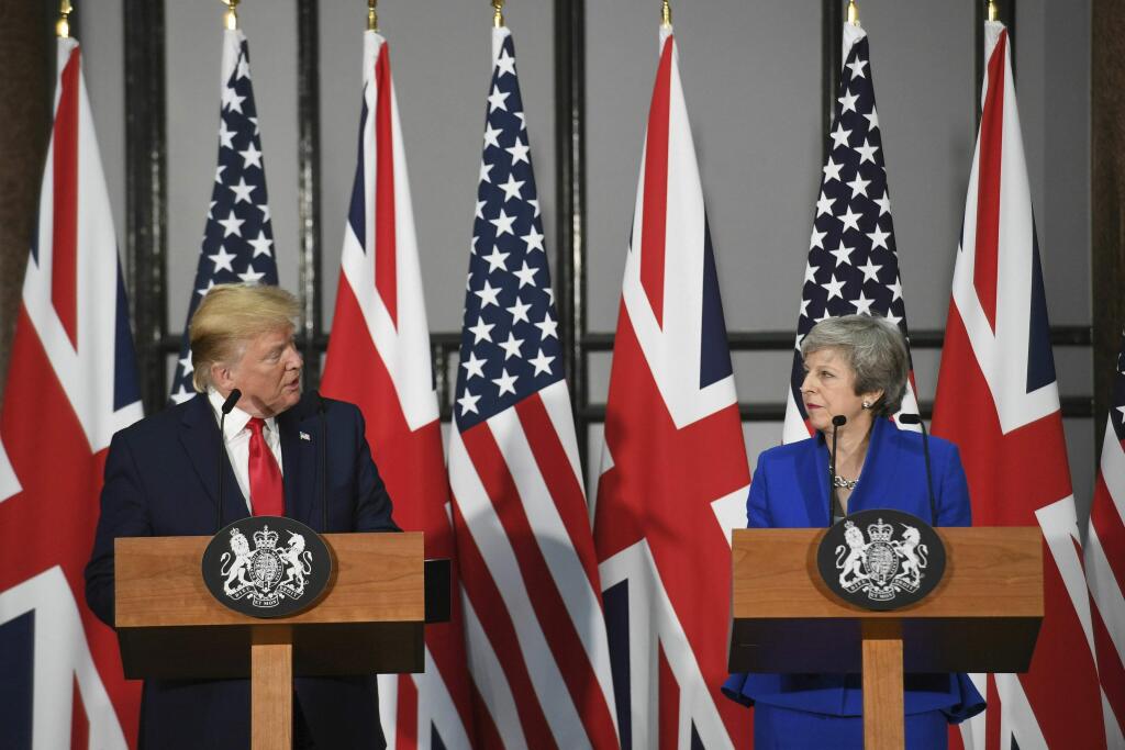 Britain's Prime Minister Theresa May and US President Donald Trump take part in a joint press conference at the Foreign & Commonwealth Office, in London, Tuesday June 4, 2019. Moving from pageantry to policy during his state visit to Britain, President Donald Trump on Tuesday urged embattled Prime Minister Theresa May to 'stick around' to complete a U.S.-U.K. trade deal, adding to this recent chapter of uncertainty in the allies' storied relationship. (Stefan Rousseau/Pool via AP)