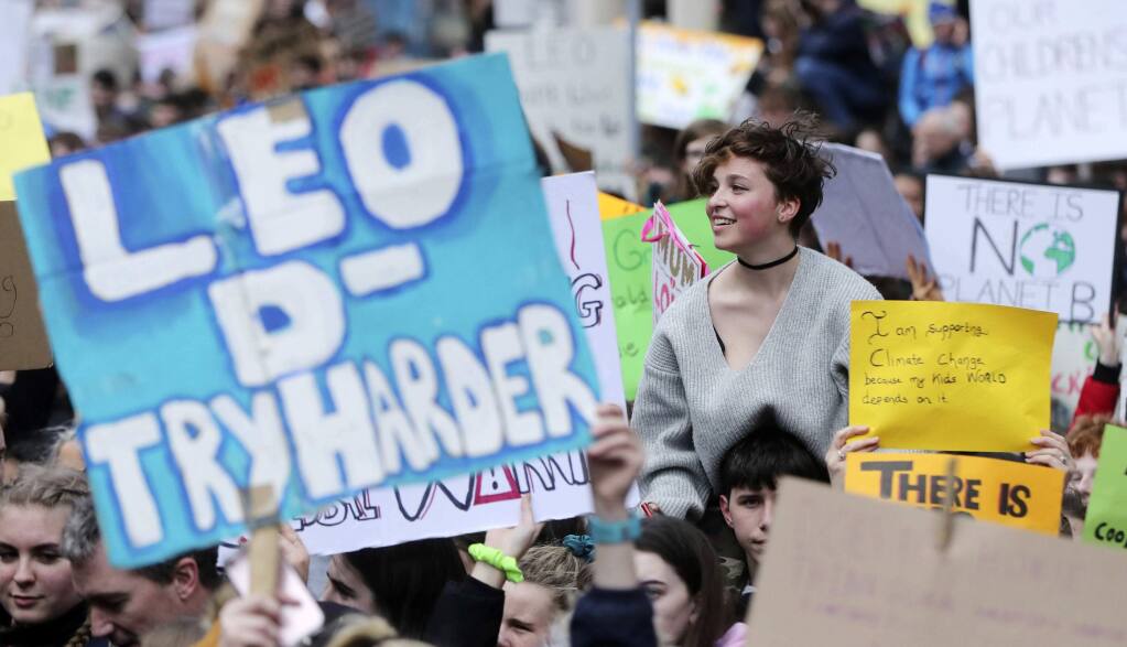 Thousands of students march from St Stephens Green to Leinster House, Dublin, Friday March 15, 2019. Students mobilized by word of mouth and social media skipped class Friday to protest what they believe are their governments' failure to take though action against global warming. (Niall Carson//PA via AP)