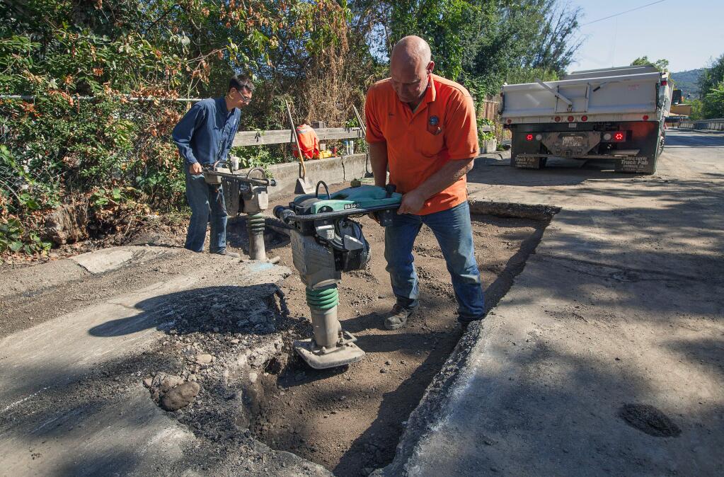 Robbi Pengelly/Index-TribuneWorkers from the Valley of the Moon Water District finish up repairs on a water main that sprung a leak on Boyes Boulevard just west of the Sonoma Creek Bridge.