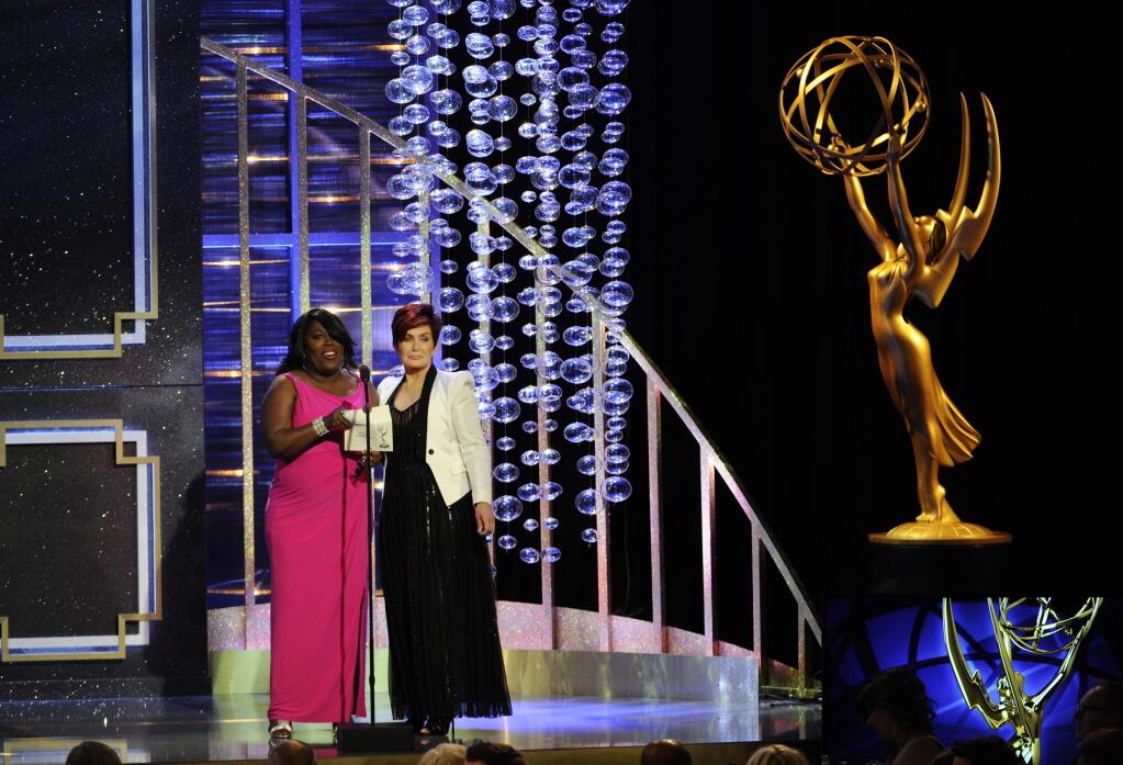 FILE - In this June 22, 2014 file photo, Sheryl Underwood, left, and Sharon Osbourne present the award for outstanding lead actor in a drama series at the 41st annual Daytime Emmy Awards in Beverly Hills, Calif. The Daytime Emmys ceremony is returning to television with a new home on the Pop channel. The National TV academy and Pop, formerly the TV Guide Network, made the announcement Monday, March 2, 2015. The ceremony will air live from a Warner Bros. studio soundstage. (Photo by Chris Pizzello/Invision/AP, File)
