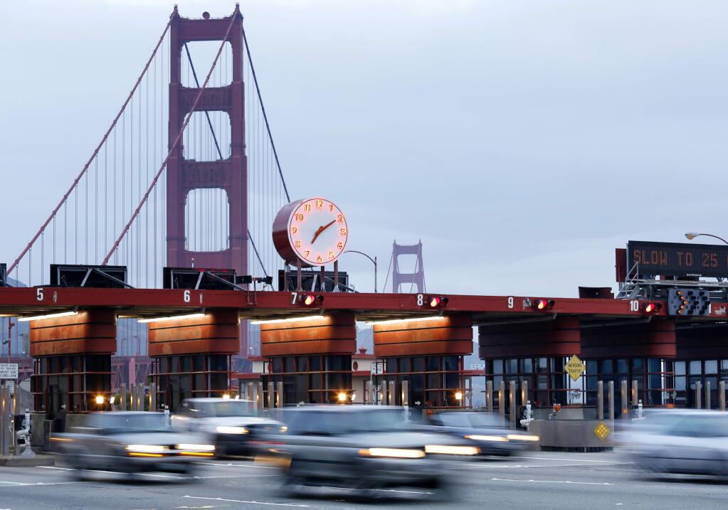Vehicles pass through the Golden Gate Bridge toll plaza in San Francisco. (CONNER JAY / The Press Democrat, 2014)