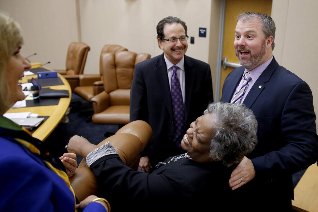 4th District Supervisor James Gore, right, talks with Susan Gorin, the 1st District Supervisor, Gloria Colter, Chief Deputy Registrar of Voters, and Bruce Goldstein, Sonoma County Counsel, before the start of the Sonoma County Board of Supervisors meeting in Santa Rosa, California on Tuesday, January 6, 2015. (BETH SCHLANKER/ The Press Democrat)