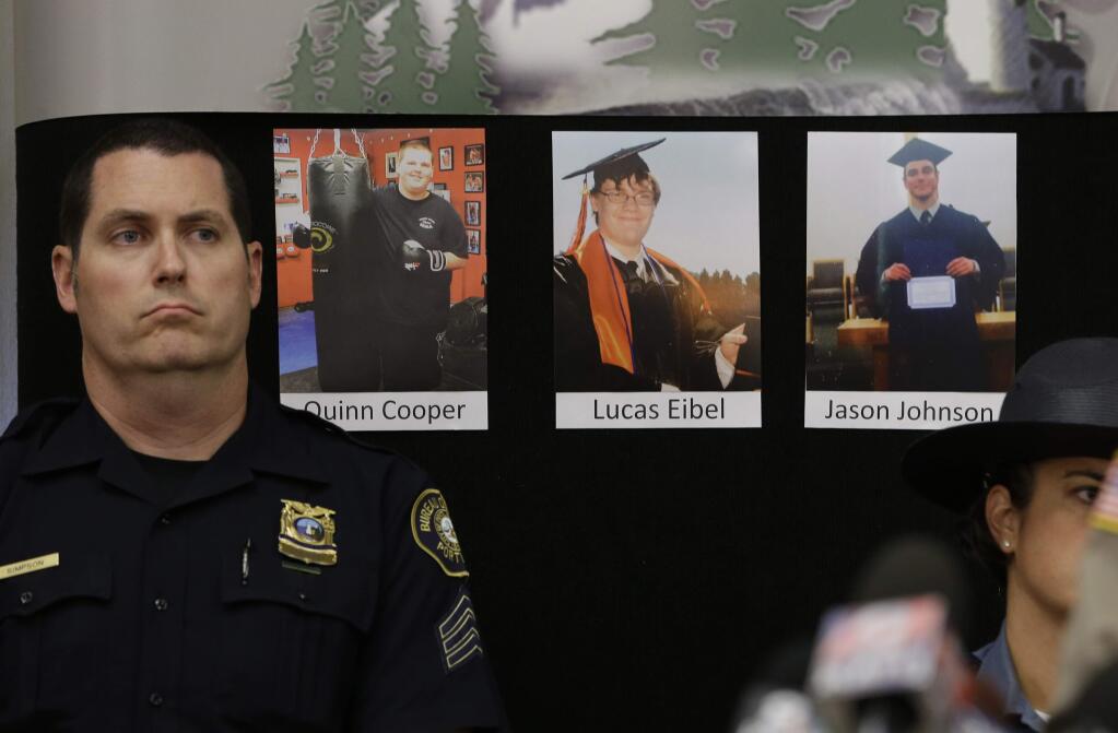 The photos of three of the victims of the mass shooting at Umpqua Community College are displayed at a news conference, Friday, Oct. 2, 2015, in Roseburg, Ore. In the photos, from left, are Quinn Cooper, 18, Lucas Eibel,18, center, and Jason Johnson, 33. They were among those killed when Chris Harper Mercer, walked into a class at the community college, Thursday, and opened fire. At left is Portland Police Sgt. Pete Simpson.(AP Photo/Rich Pedroncelli)