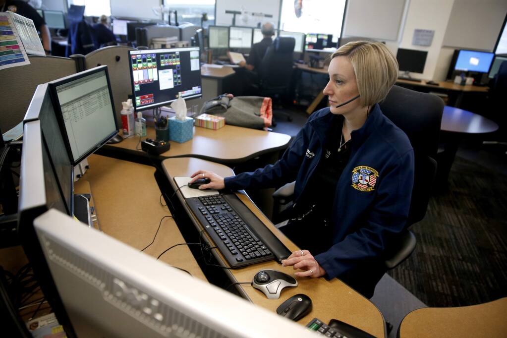 KT McNulty, a supervising dispatcher, oversees a call during a training session at the REDCOM dispatch office on Wednesday, Feb. 14, 2018 in Santa Rosa. (BETH SCHLANKER/The Press Democrat)