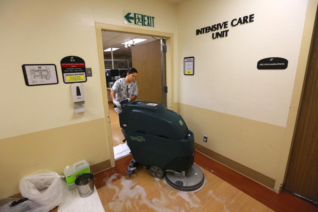 Hilda Racil cleans the floors outside of the old Intensive Care Unit at Palm Drive Hospital in Sebastopol on Friday, August 1, 2014.