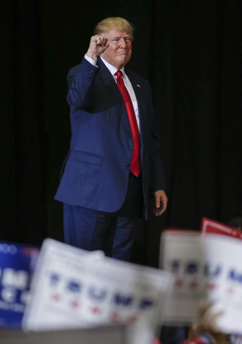 Republican presidential candidate Donald Trump raises his fist after speaks at a campaign rally in Grand Rapids, Mich., Monday, Oct. 31, 2016. (AP Photo/Nati Harnik)