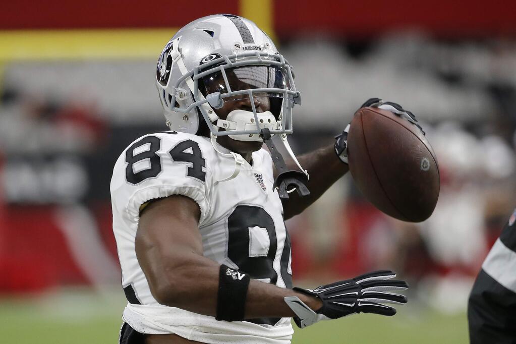 Oakland Raiders wide receiver Antonio Brown (84) warms up prior to an NFL football game against the Arizona Cardinals, Thursday, Aug. 15, 2019, in Glendale, Ariz. (AP Photo/Rick Scuteri)