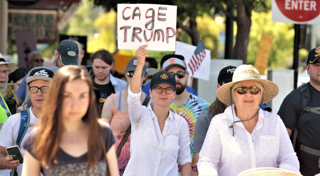 Protesters carrying signs and chanting, march on 4th Street in Petaluma in the Families Belong Together March, Saturday June 30, 2018. (Photo Will Bucquoy / For the Press Democrat).