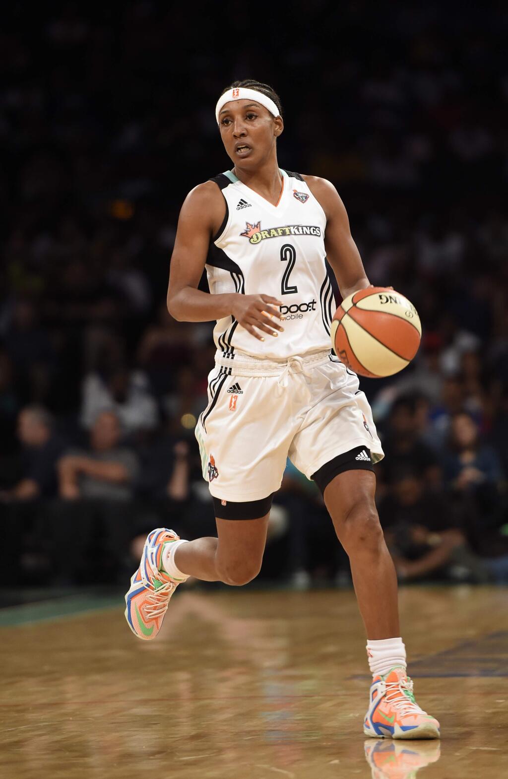 FILE - In this July 16, 2015, file photo, New York Liberty guard Candice Wiggins brings the ball up during the team's WNBA basketball game against the Connecticut Sun in New York. Wiggins said her experience playing in the WNBA was 'toxic' and was a major reason why she retired last season. In an interview with The San Diego Union-Tribune, Wiggins said the culture in the league was 'very, very harmful' and that she was targeted throughout her career for being heterosexual and popular. (AP Photo/Kathy Kmonicek, File)