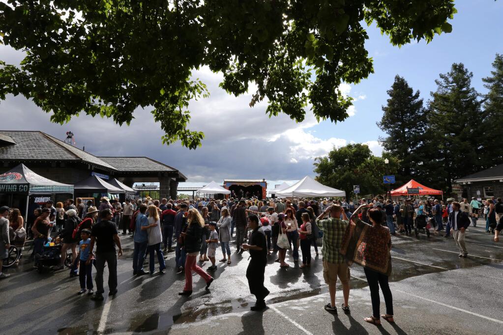 People watch the Earles of Newtown perform at the Newtown stage after a rain downpour at the Railroad Square Music Festival in Santa Rosa, Calif., on Sunday, June 11, 2017. (Photo by Darryl Bush / For The Press Democrat)