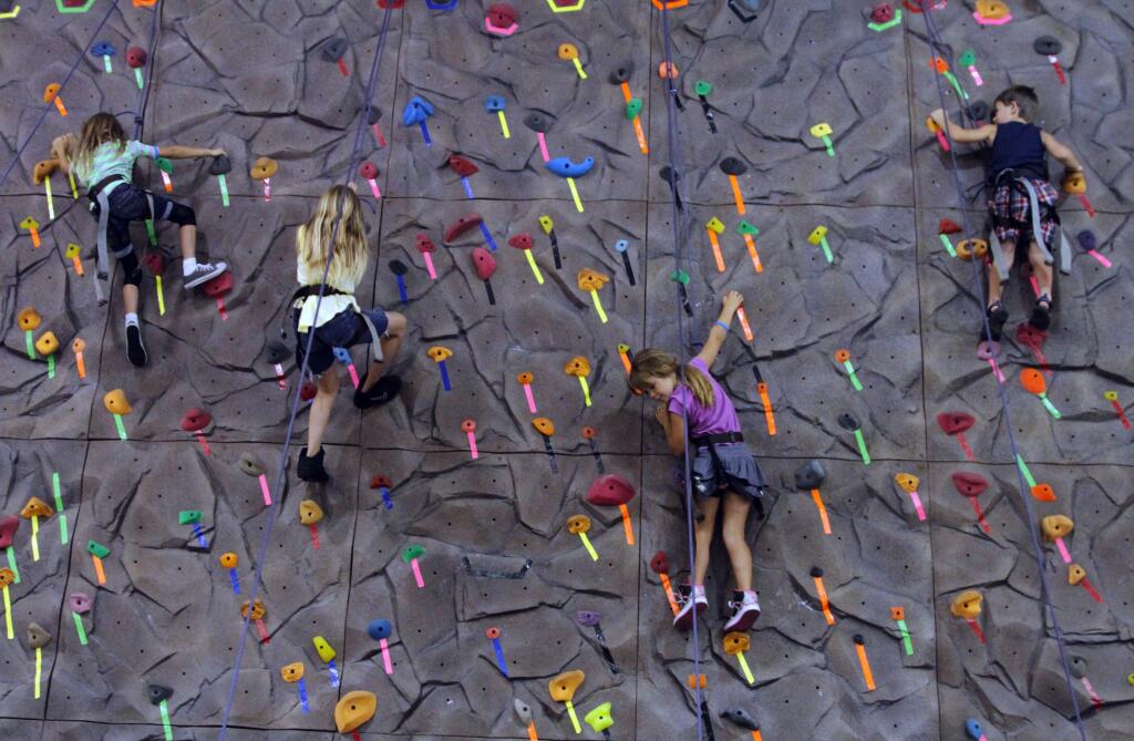 Bill Hoban/Index-Tribne file photoChildren work their way up the climbing wall at the Boys & Girls Club.
