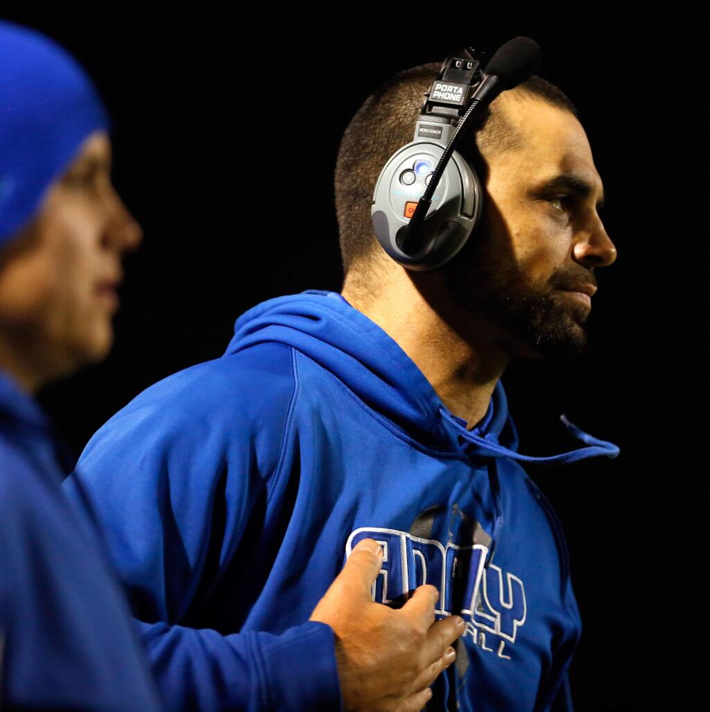 Analy head coach Daniel Bourdon calmly signals a play during the first half of the NCS Division 3 championship football game between Analy and Campolindo high schools in Pleasant Hill, California on Friday, December 4, 2015. (Alvin Jornada / The Press Democrat)