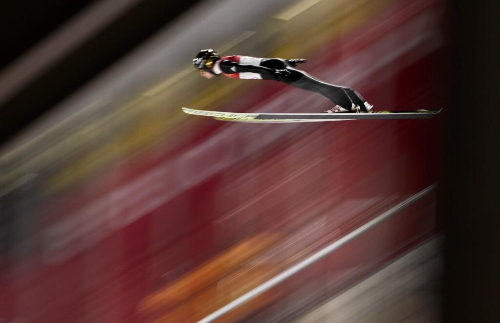 Andreas Wellinger, of Germany, soars through the air during the men's normal hill individual ski jumping qualifier ahead of the 2018 Winter Olympics in Pyeongchang, South Korea, Thursday, Feb. 8, 2018. (AP Photo/Matthias Schrader)