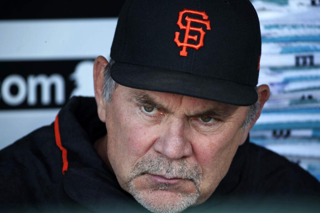 In this May 11, 2018 file photo, San Francisco Giants manager Bruce Bochy sits in the dugout before a game against the Pittsburgh Pirates in Pittsburgh. (AP Photo/Gene J. Puskar, File)