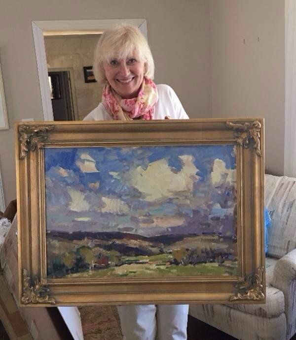 Sonoma Plein Air boardmember Irene Cook shows off a piece by by notable artist Eric Jacobsen that will be on exhibit this month at the Invitational Exhibit.