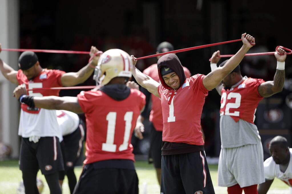 San Francisco 49ers players stretch during an NFL football practice Thursday, June 9, 2016, in Santa Clara, Calif. (AP Photo/Marcio Jose Sanchez)