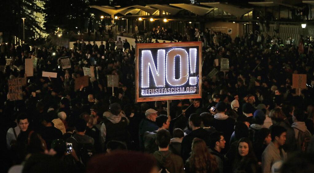 Protestors against a scheduled speaking appearance by polarizing Breitbart News editor Milo Yiannopoulos fill Sproul Plaza on the University of California at Berkeley campus on Wednesday, Feb. 1, 2017, in Berkeley, Calif. The event was canceled out of safety concerns after protesters hurled smoke bombs, broke windows and started a bonfire. (AP Photo/Ben Margot)