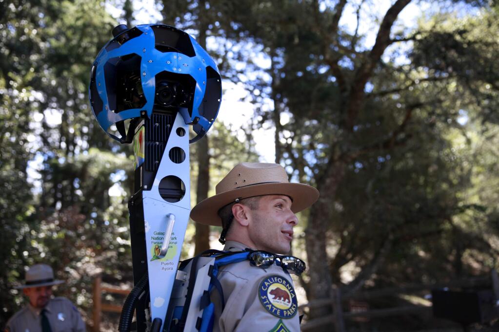 Roberto Walton, a supervising ranger for California State Parks, tries on the Google Trekker, a street view camera mounted in a backpack, at Mount Tamalpais State Park on Tuesday, October 7, 2014 near Mill Valley , California. (BETH SCHLANKER/ The Press Democrat)