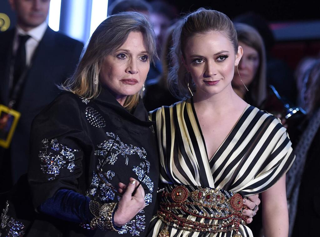 FILE- In this Dec. 14, 2015, file photo, Carrie Fisher, left, and daughter Billie Lourd arrive at the world premiere of 'Star Wars: The Force Awakens' at the TCL Chinese Theatre in Los Angeles. Lourd says the support she's received since the death of her mother and her grandmother, Debbie Reynolds, has given her strength. (Photo by Jordan Strauss/Invision/AP, File)