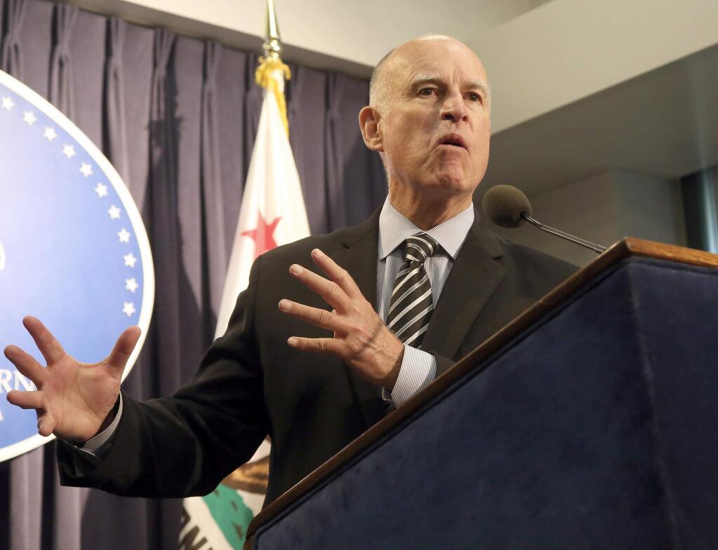California Gov. Jerry Brown speaks before signing a bill mandating the paid leave that supporters say will guarantee that workers don't lose their jobs or their paychecks if they or a family member gets sick, in Los Angeles Wednesday, Sept. 10, 2014. (AP Photo/Nick Ut)