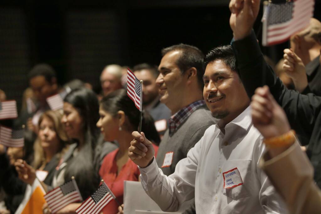 Mexican immigrant Heriberto Herrera reacts after taking the Oath of Allegiance during a U.S. naturalization ceremony at the Napa Valley College Performing Arts Center on Thursday, March 31, 2016 in Napa, California . (BETH SCHLANKER/ The Press Democrat)
