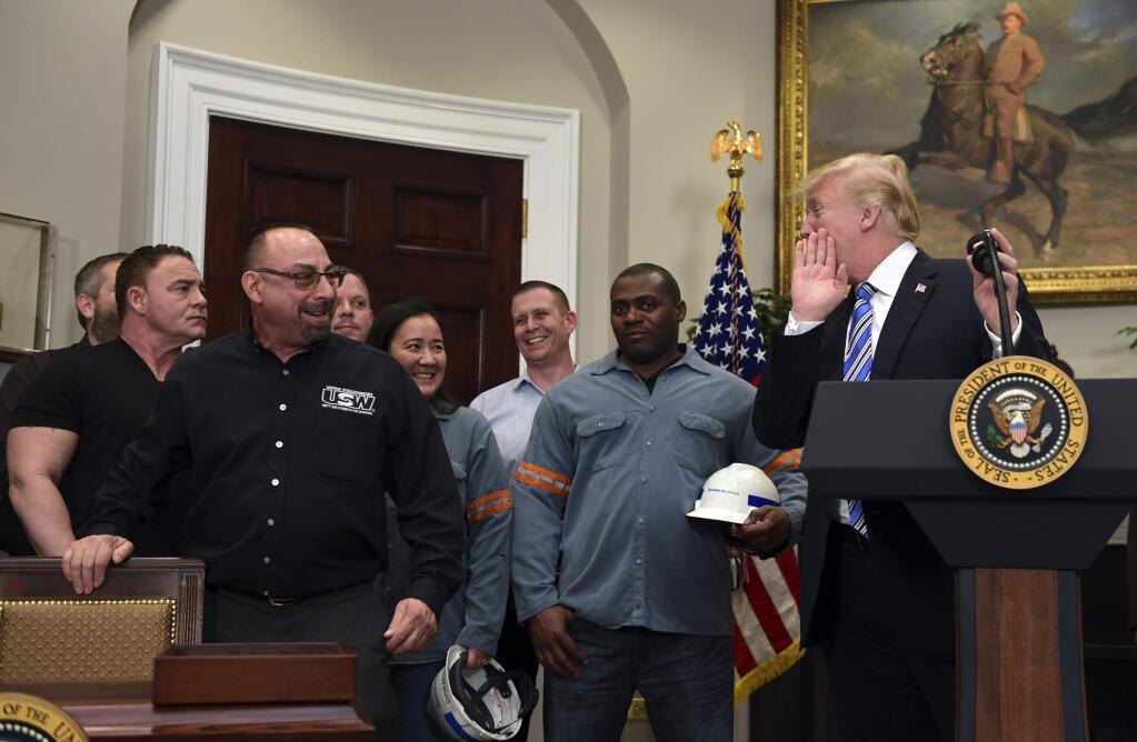 President Donald Trump, right, talks to Scott Sauritch, a maintenance worker at Irvin Works and President of Local 2227, during an event in the Roosevelt Room of the White House in Washington, Thursday, March 8, 2018. Trump signed two proclamations, one on steel imports and the other on aluminum imports. (AP Photo/Susan Walsh)