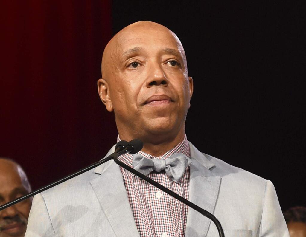 FILE - In this July 18, 2015 file photo, Russell Simmons speaks appears at the RUSH Philanthropic Arts Foundation's Art for Life Benefit in Water Mill, N.Y. Three women have told the New York Times that music mogul Russell Simmons raped them. Simmons, in a statement to the paper, vehemently denied what he called ‚Äúthese horrific accusations,‚Äù saying all his relations have been consensual. (Photo by Scott Roth/Invision/AP, File)