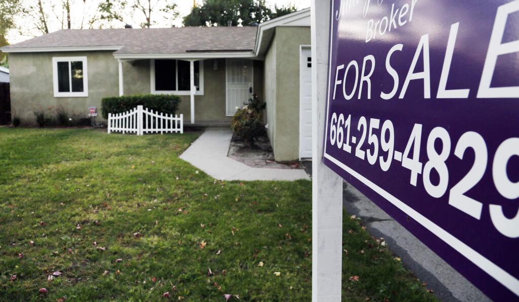 File - In this Nov. 3, 2014 file photo is a house for sale in Los Angeles. Analysis by Reveal from The Center for Investigative Reporting found Latinos accounted for nearly half of the population in the Los Angeles area in 2015-2016, yet made up just 18 percent of conventional loan applications. (AP Photo/Richard Vogel, File)
